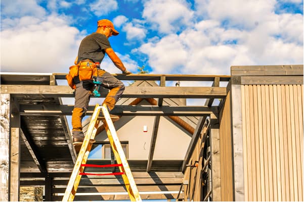 Extension ladder against a two-story house
